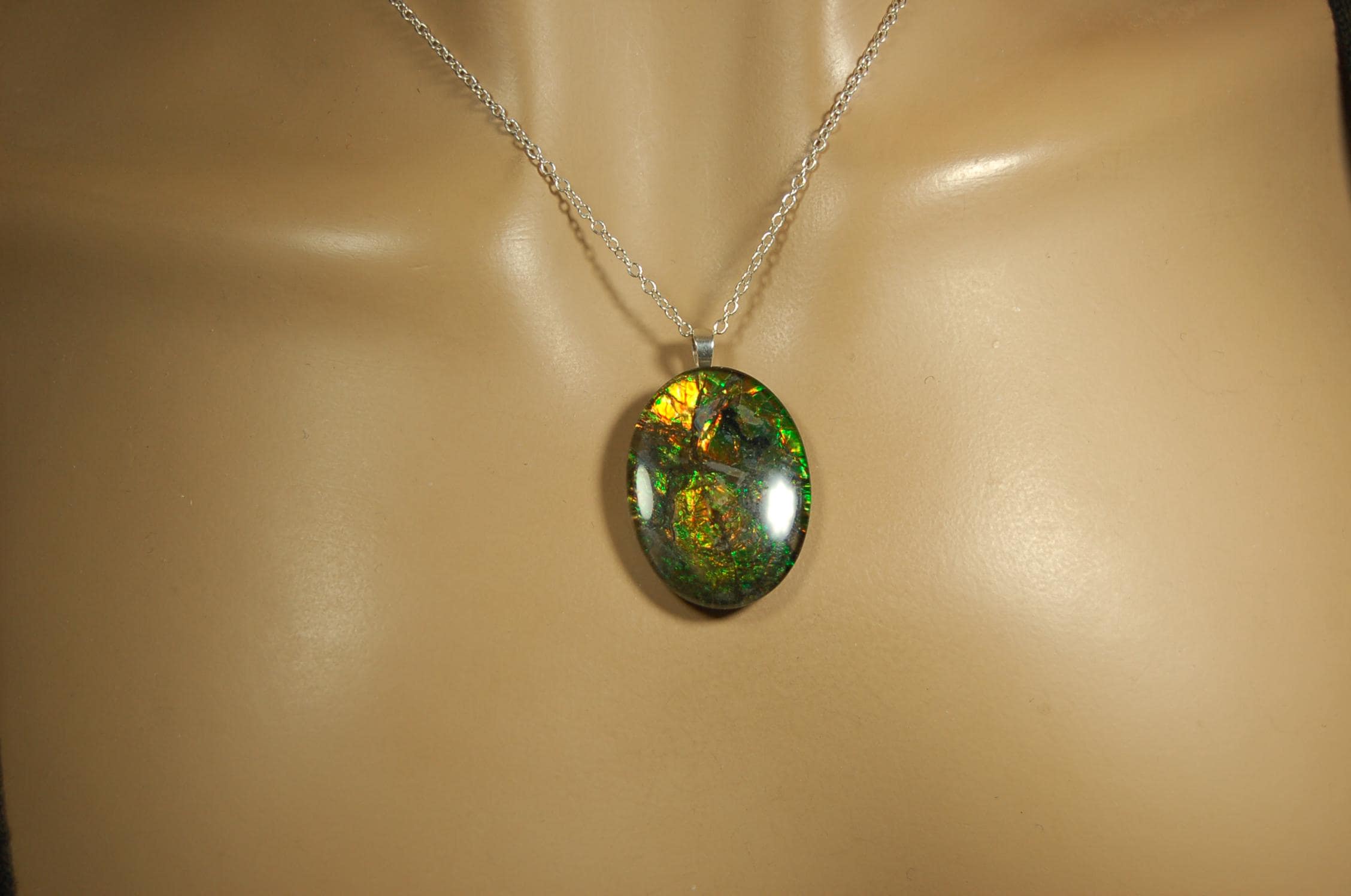 Ammolite cabochon pendant to upgrade your fashion accessory collection.Green and Copper colors.Sterling silver bail.Birthday gift? 032716