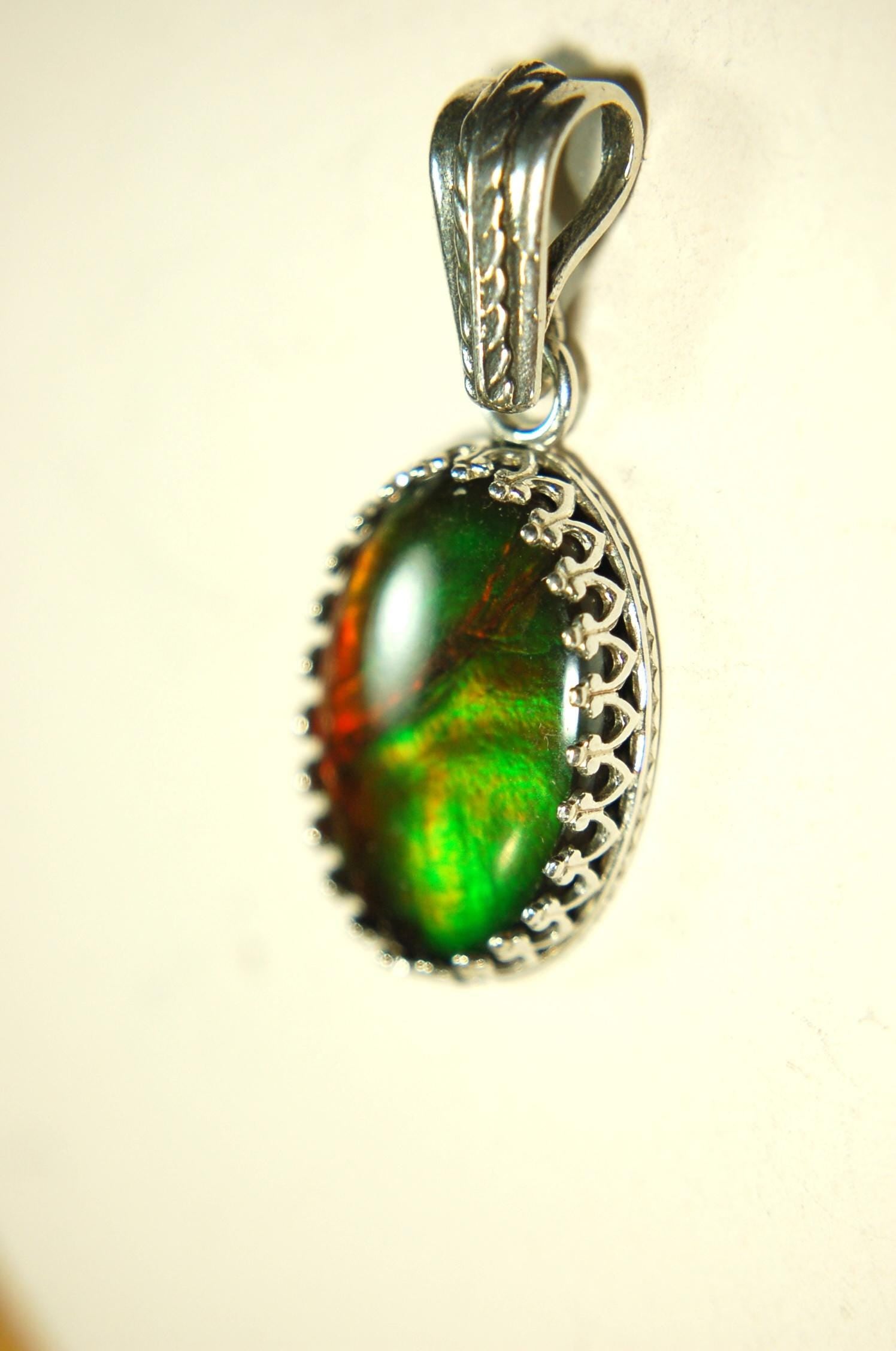 Ammolite Pendant Necklace.Resembles a fiery coal.Strong color shifter.Duty free under CUSMA rules.022115