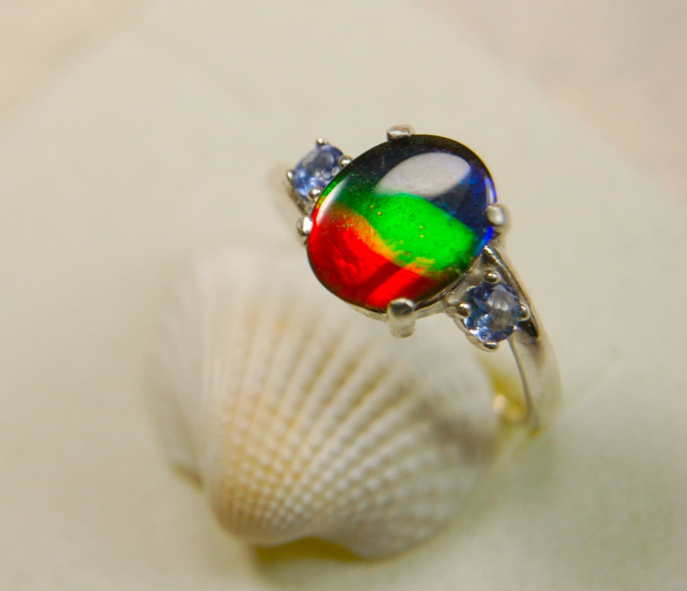 Ammolite Ring with brilliant colors and Tanzanite side stones.Size 7 #120223