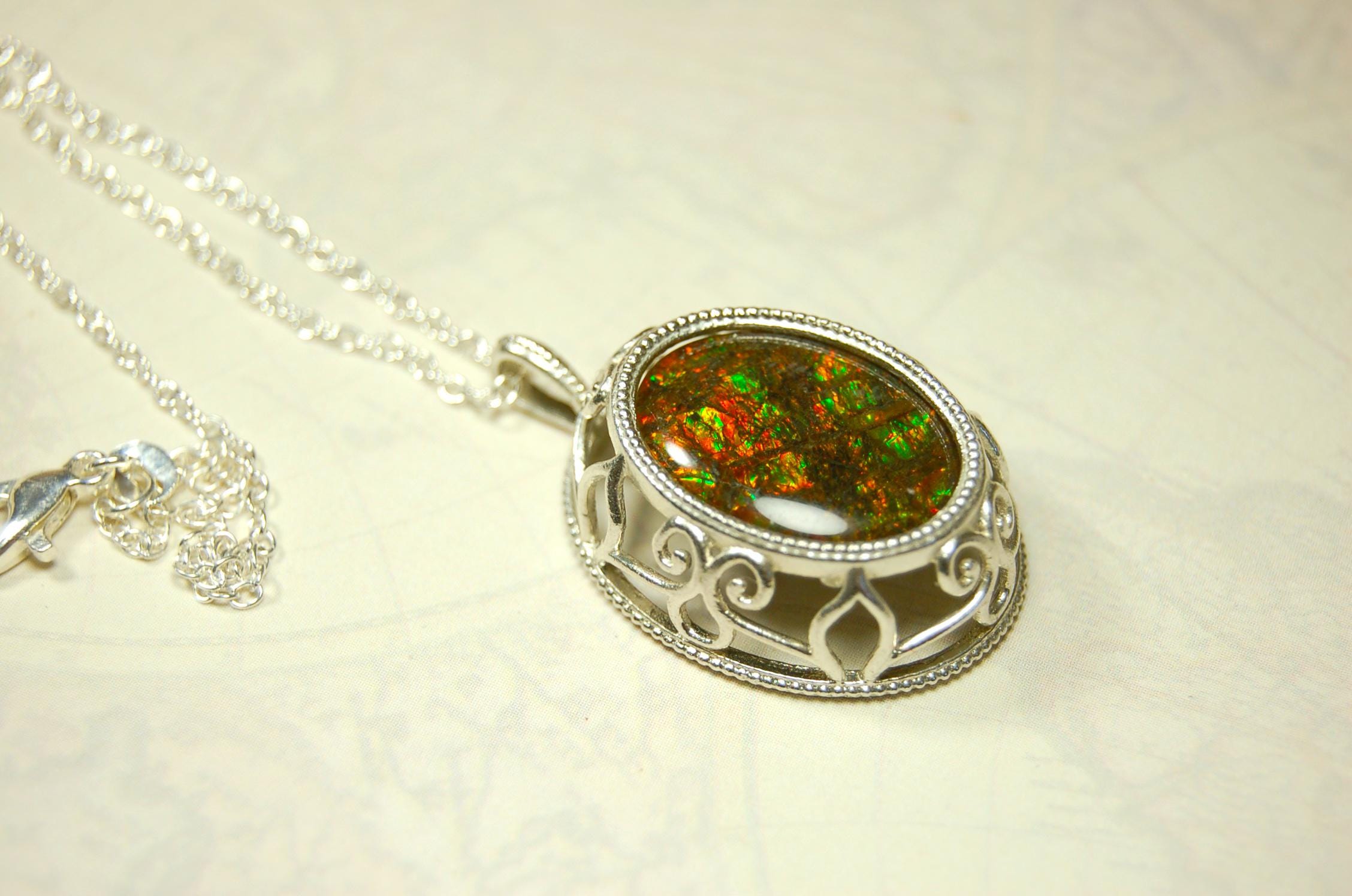 Unusual Ammolite pendant full of multicolor sparkles.A gift that will be treasured..032116