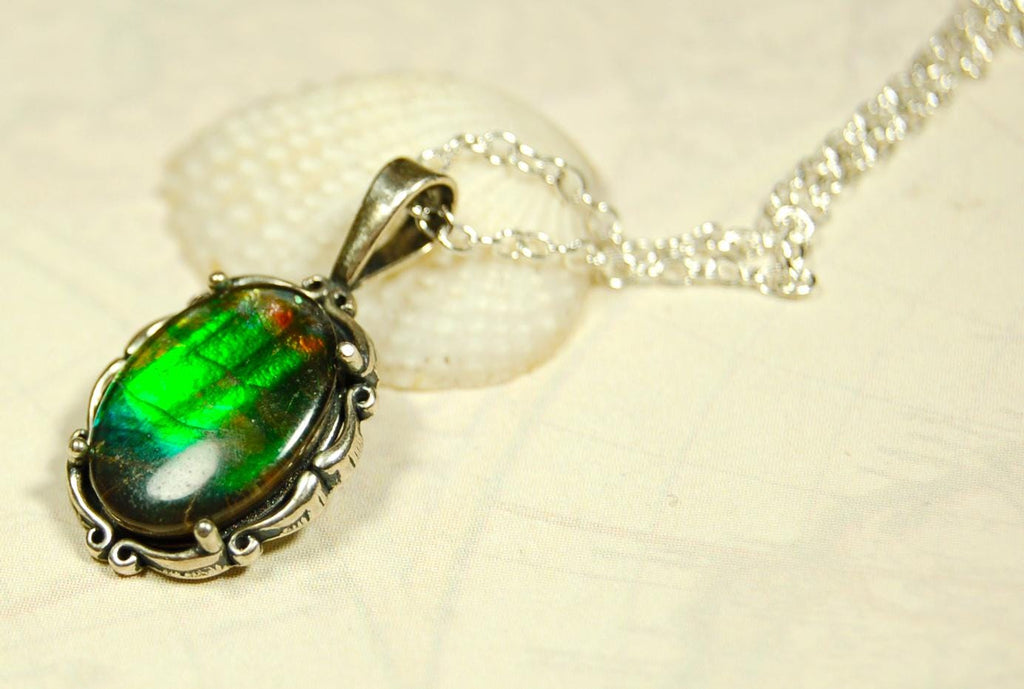 Ammolite Pendant elegantly set in sterling silver.Lovely greens and blues and flash of red.Fine anniversary gift idea for  wife.041916