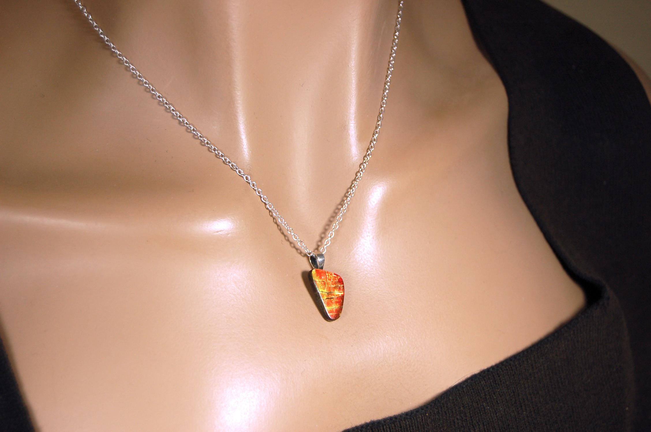 Ammolite Pendant with a gem of fire best appreciated in video.Amazing brilliance and hot colors.A big attention getter.022416