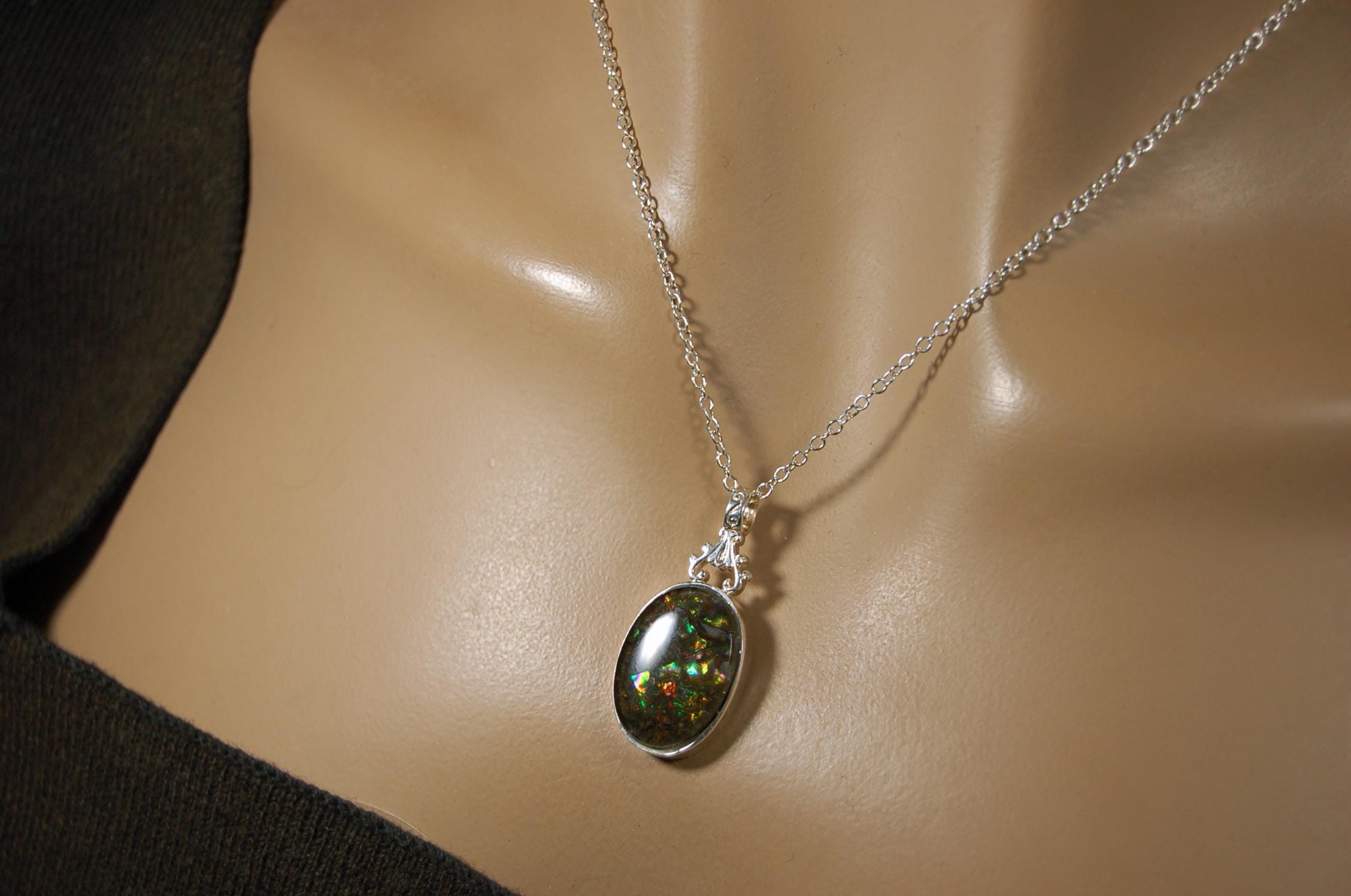 Ammolite Pendant.Rare sparks of color.Looks like a black Opal.One of a kind gem.Rare gift for her.Sterling Silver setting.022316