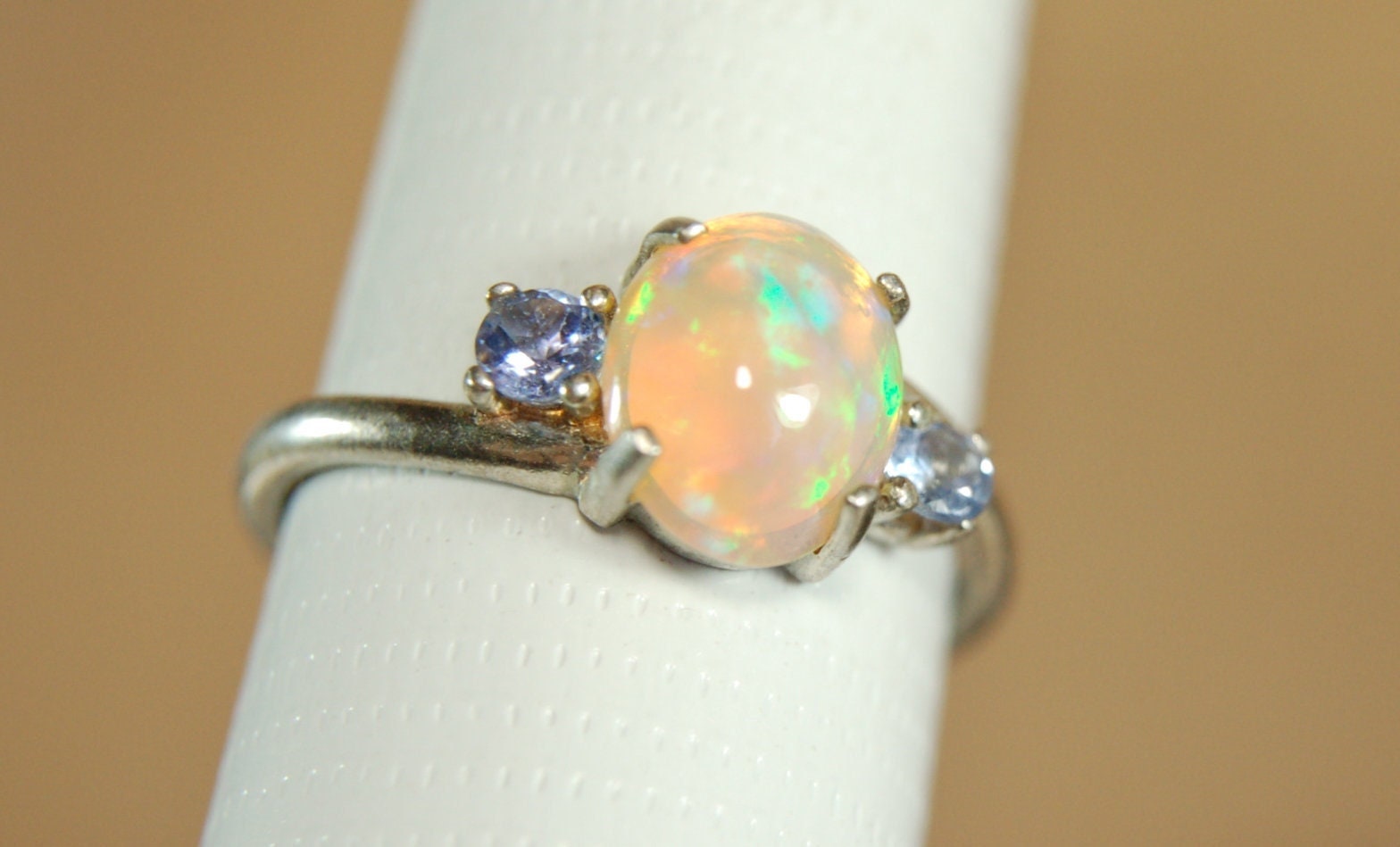 Opal ring.Solid African opal set in sterling silver with London Blue Topaz accent stones.Very feminine in size 6.