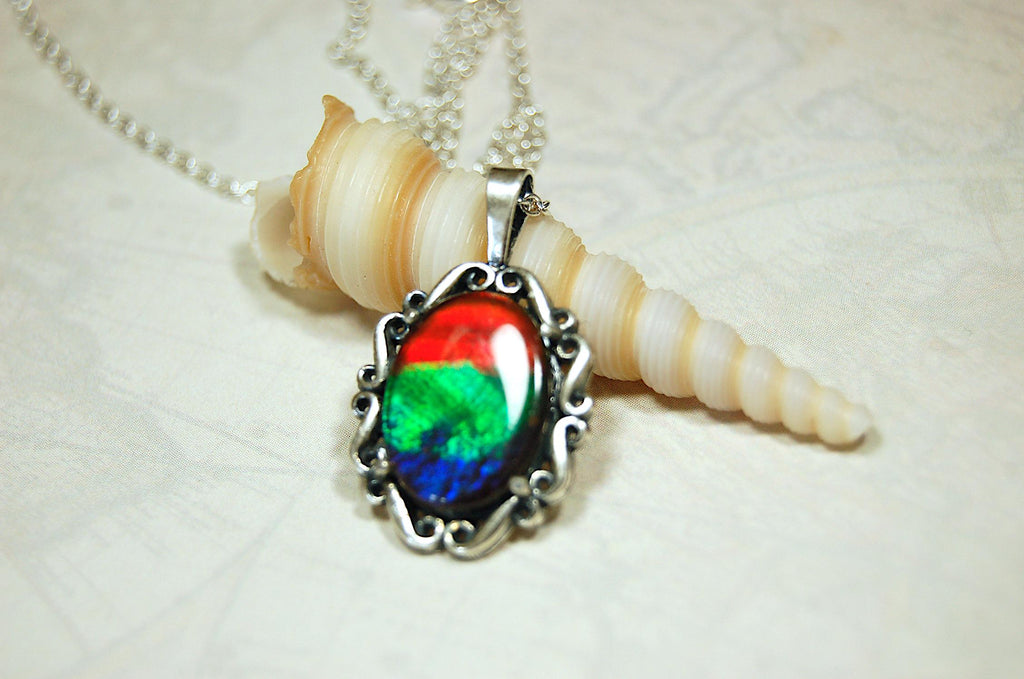 Genuine Ammolite Jewelry pendant with strong rainbow colors set in solid sterling silver.High Quality fashion accessory.