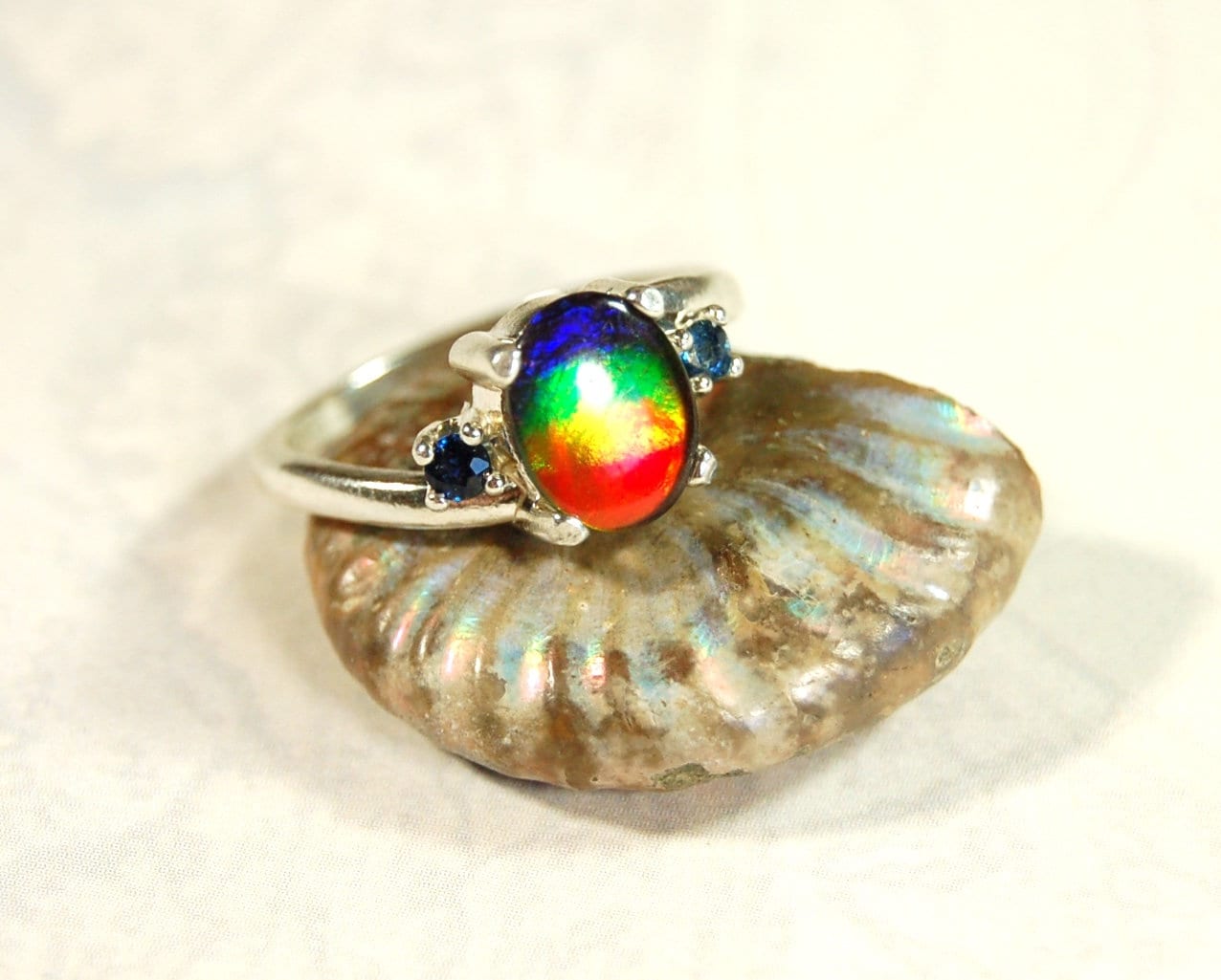 Ammolite Ring with Sapphire side stones.Lovely four color gem.Size 7.-#040314