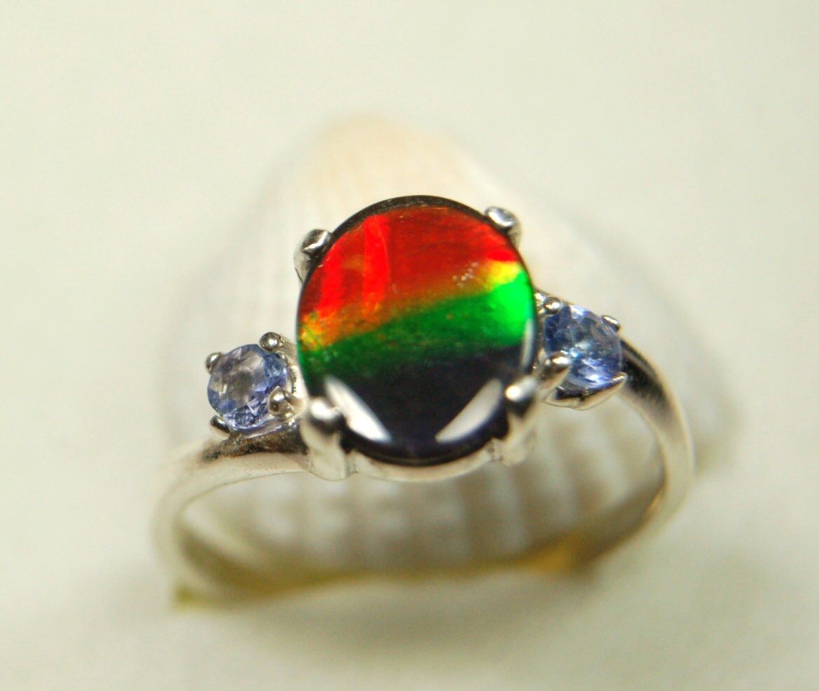 Ammolite Ring with brilliant colors and Tanzanite side stones.Size 7 #120223