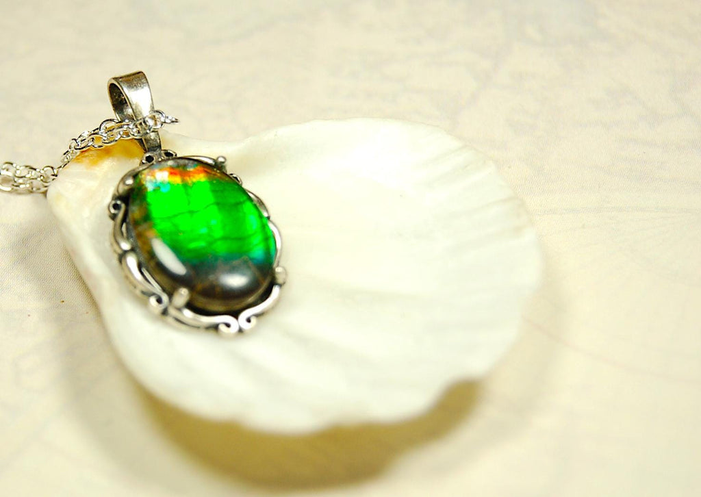 Ammolite Pendant elegantly set in sterling silver.Lovely greens and blues and flash of red.Fine anniversary gift idea for  wife.041916