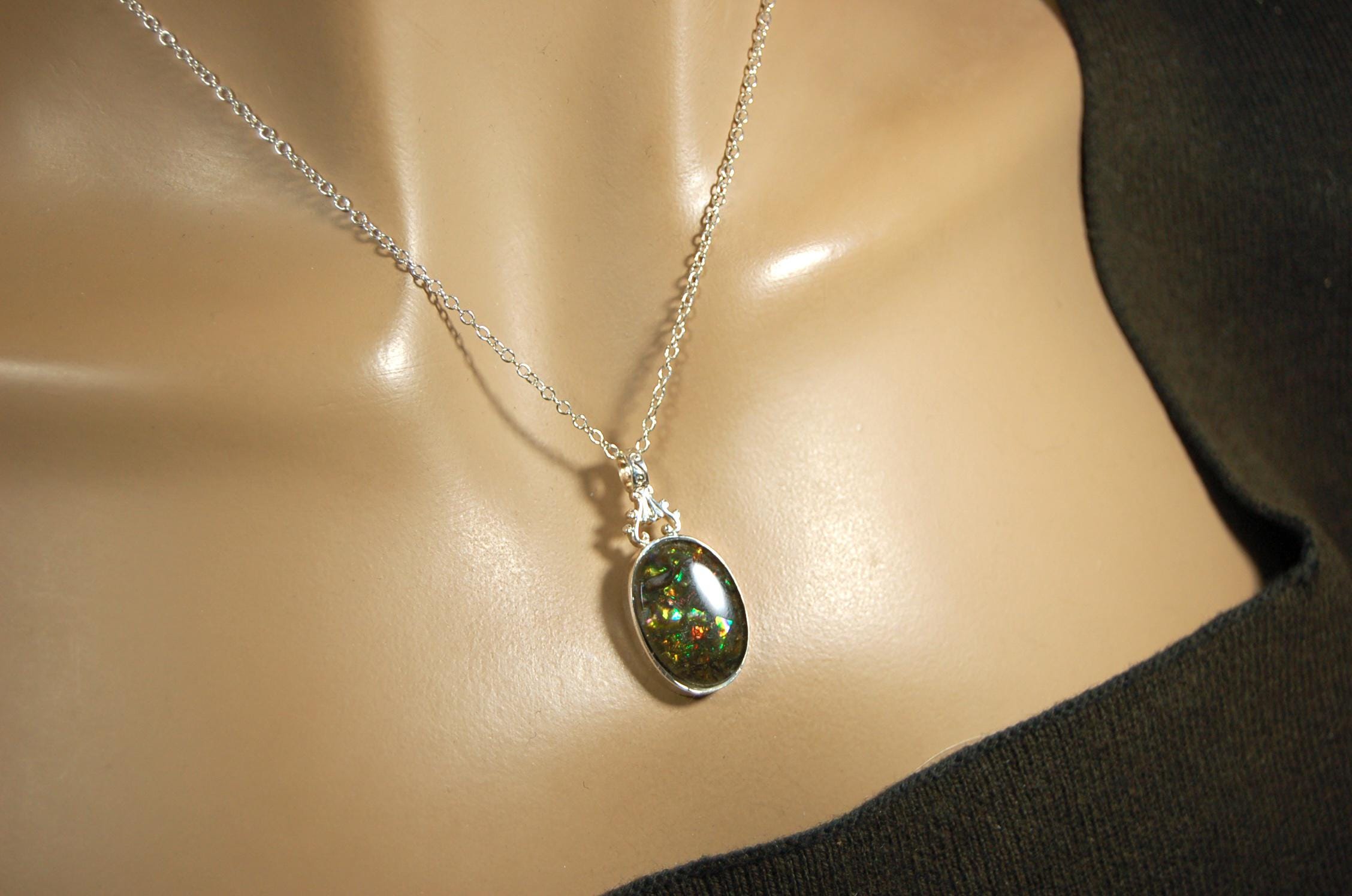 Ammolite Pendant.Rare sparks of color.Looks like a black Opal.One of a kind gem.Rare gift for her.Sterling Silver setting.022316
