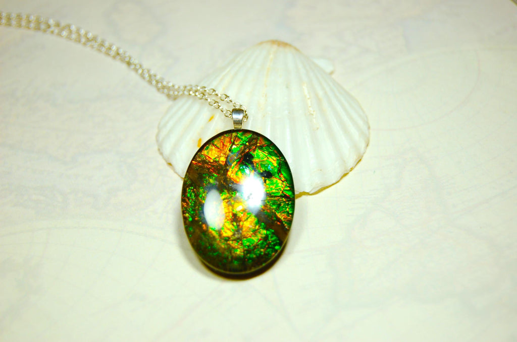 Ammolite cabochon pendant to upgrade your fashion accessory collection.Green and Copper colors.Sterling silver bail.Birthday gift? 032716