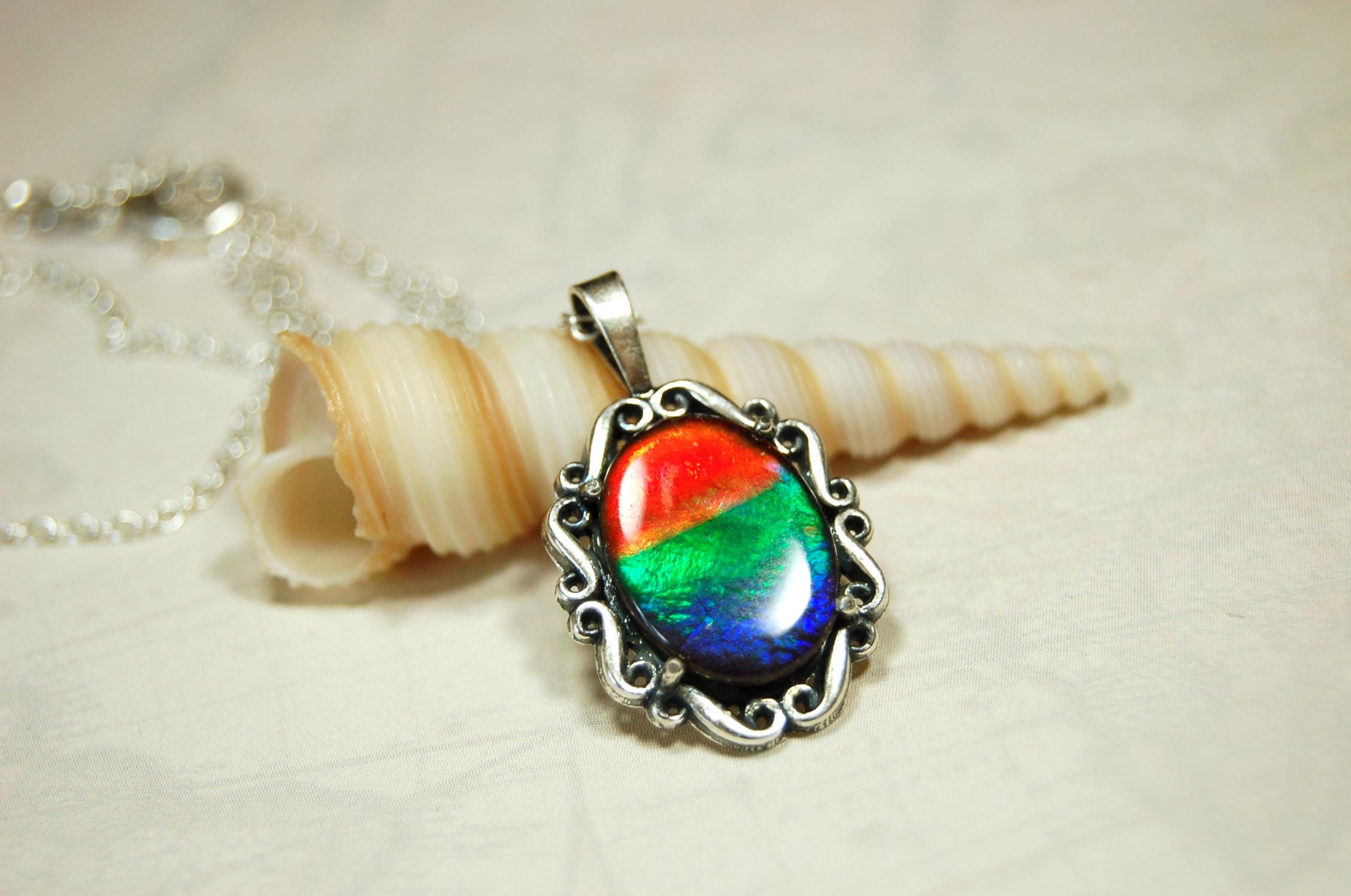 Genuine Ammolite Jewelry pendant with strong rainbow colors set in solid sterling silver.High Quality fashion accessory.
