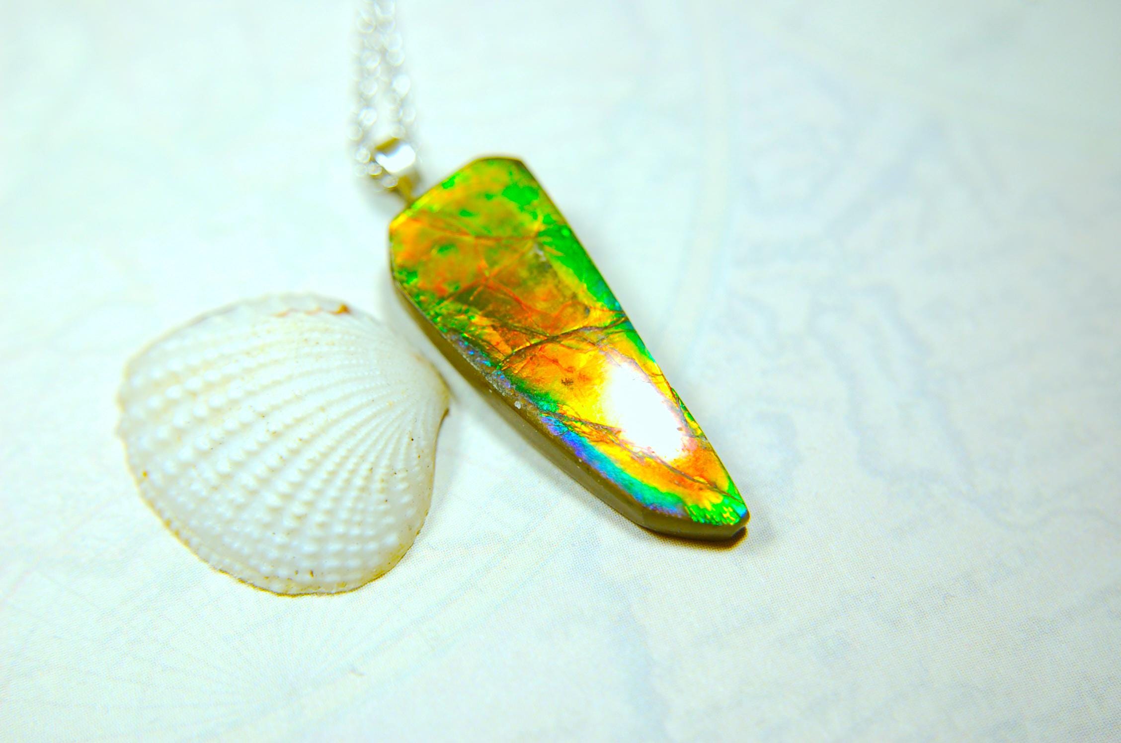 Ammolite necklace pendant.Natural rainbow cabochon of many bright colors.Strong color shifter.Video shows color best.030116