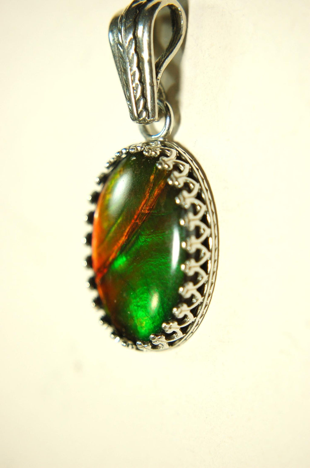 Ammolite Pendant Necklace.Resembles a fiery coal.Strong color shifter.Duty free under CUSMA rules.022115