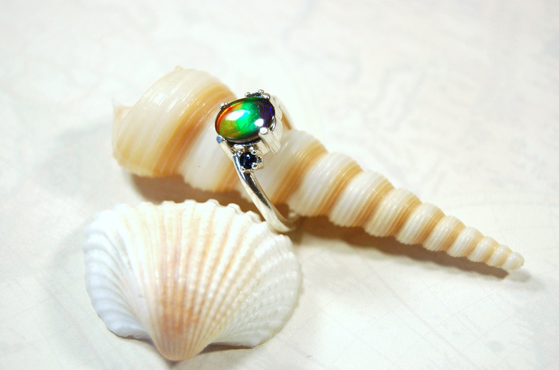 Ammolite Ring with Sapphire side stones.Lovely four color gem.Size 7.-#040314