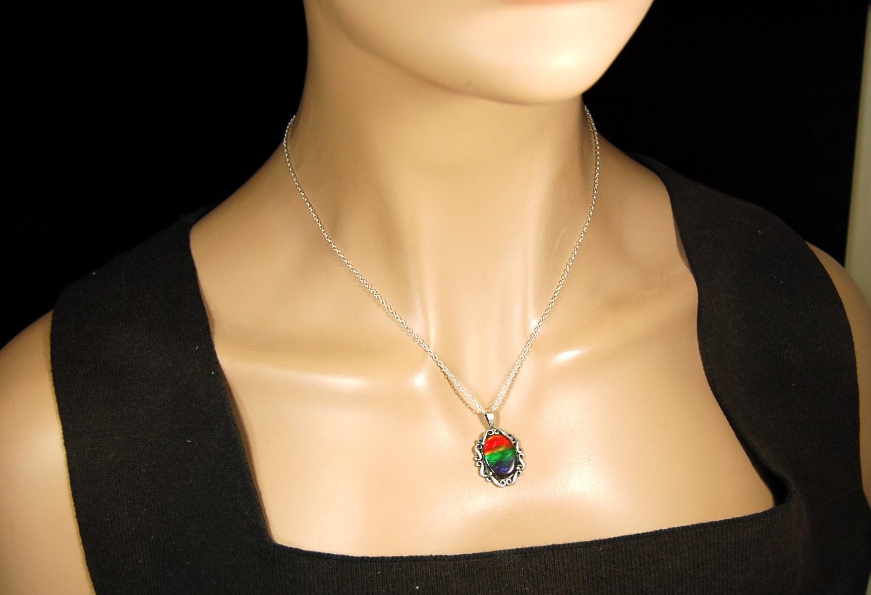 Genuine Ammolite Jewelry pendant with strong rainbow colors set in solid sterling silver.High Quality fashion accessory.
