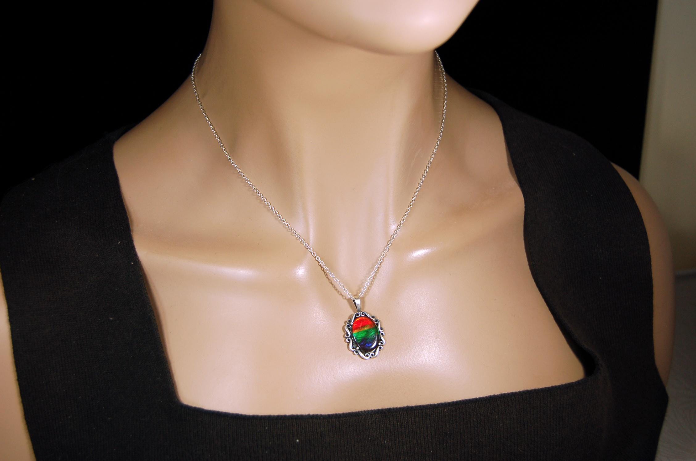 Genuine Ammolite Jewelry pendant with strong rainbow colors set in solid sterling silver.High Quality fashion accessory.