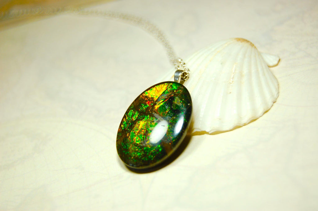 Ammolite cabochon pendant to upgrade your fashion accessory collection.Green and Copper colors.Sterling silver bail.Birthday gift? 032716