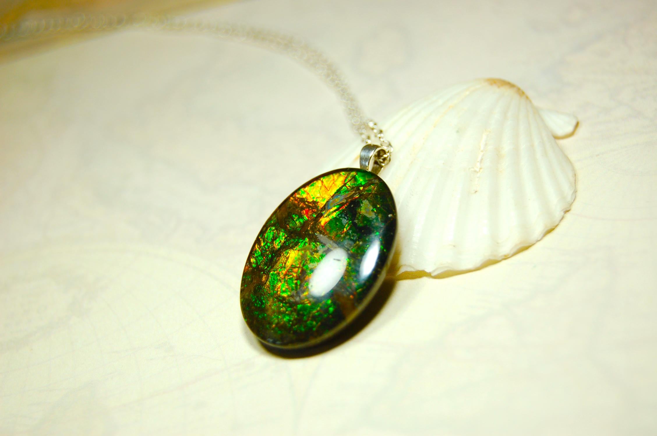 Ammolite cabochon pendant to upgrade your fashion accessory collection.Green and Copper colors.Sterling silver bail.Birthday gift? 032716