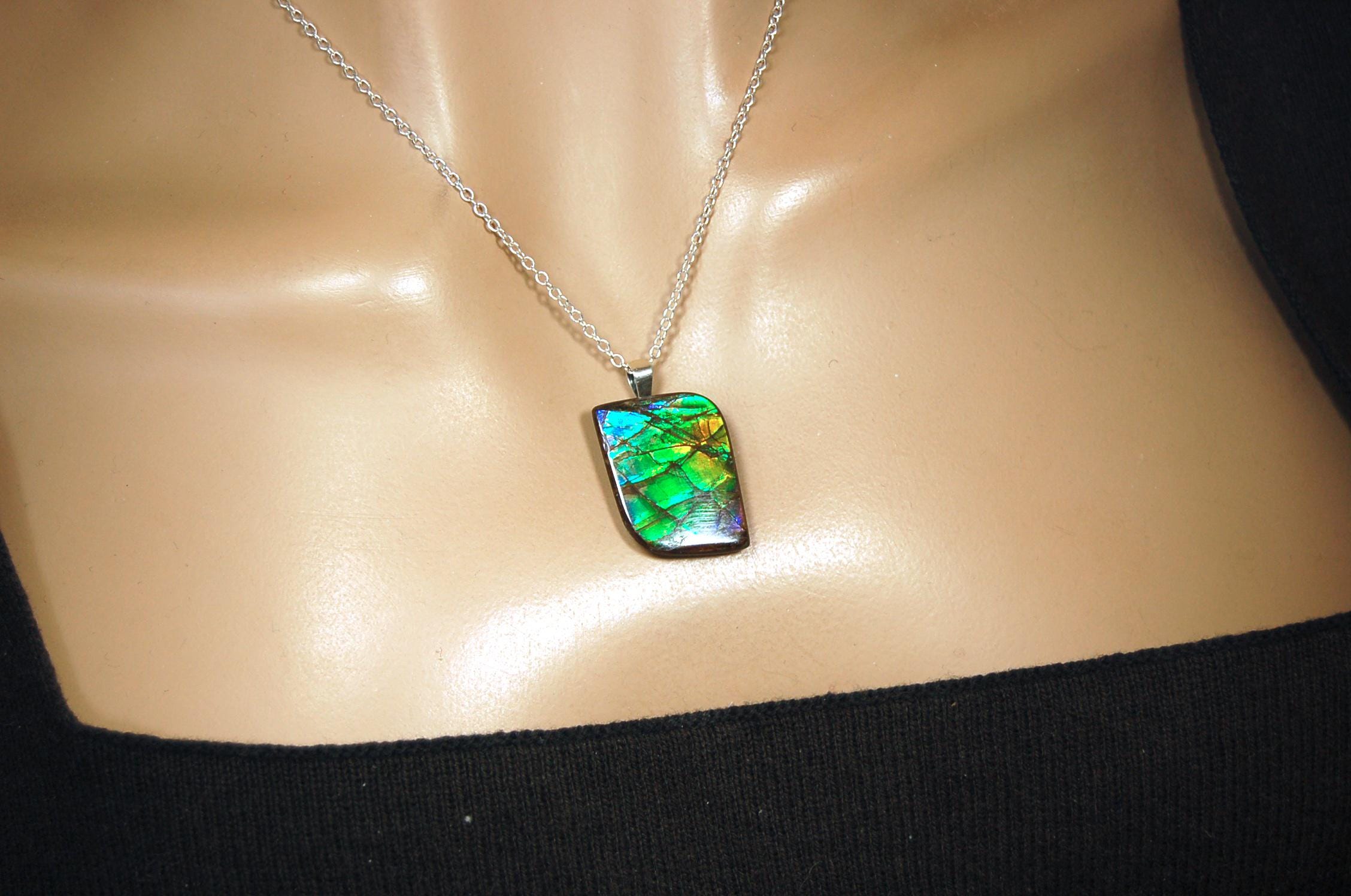 Ammolite Jewelry Pendant.Very high quality colors best seen in video.All natural cabochon gemstone from Alberta,Canada.031916