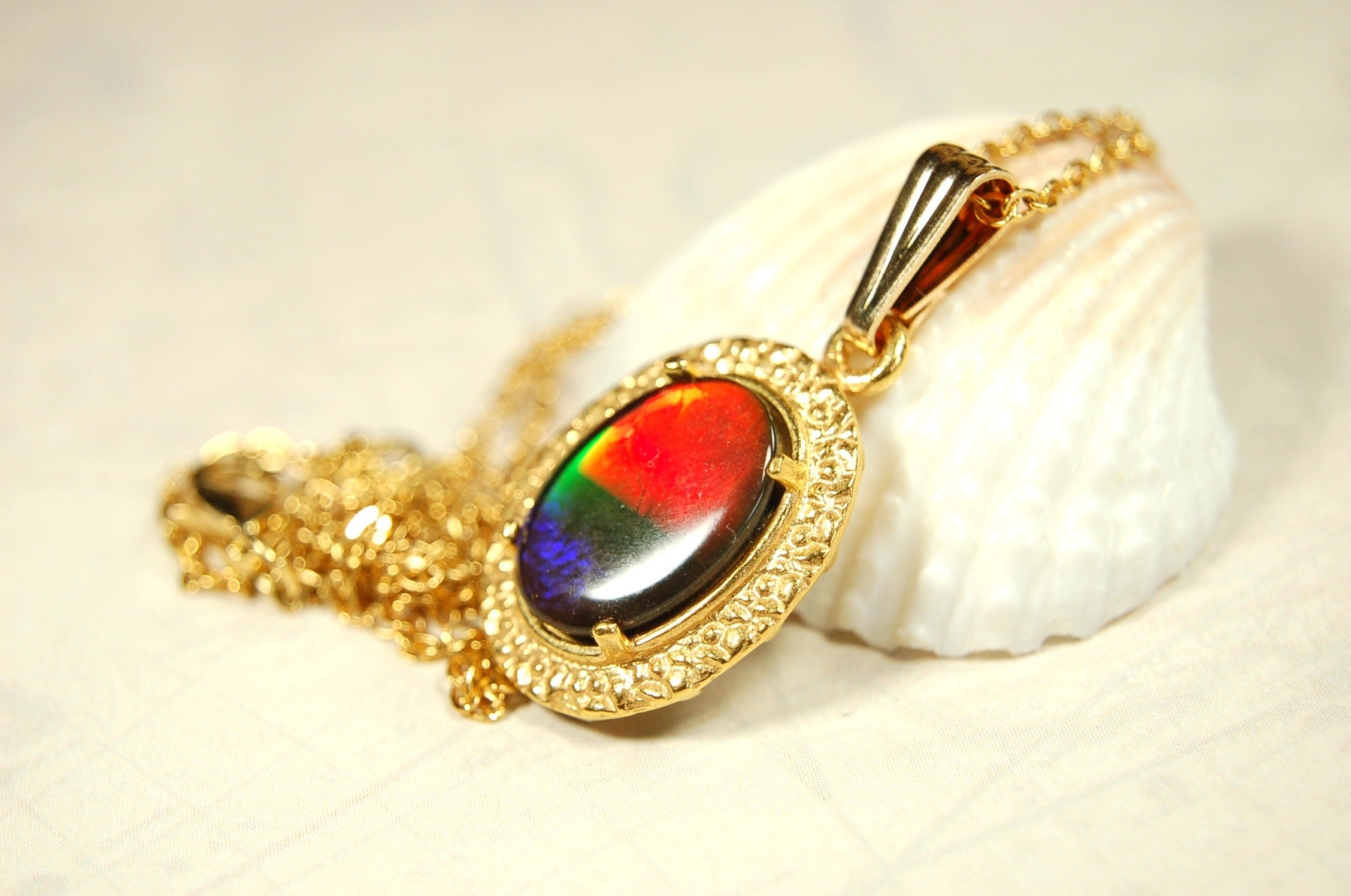 Genuine rainbow Ammolite pendant in 14k gold fill setting.#070414