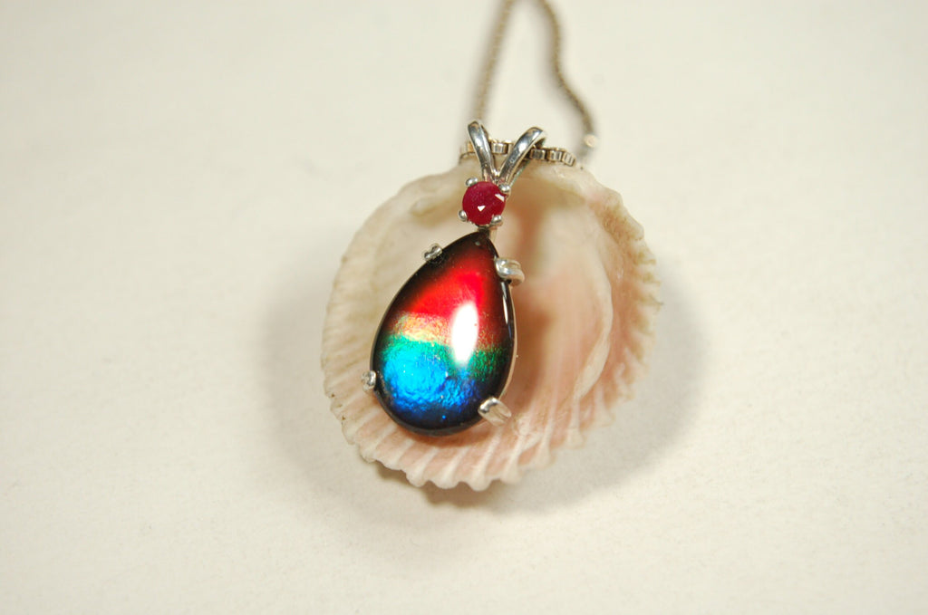Ammolite Raibow pendant.Natural ruby companion stone.Lots of bright colors.#110317
