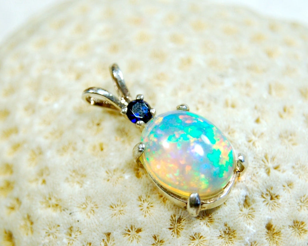 Natural opal pendant with blue sapphire.Good quality with many colors.The perfect gift.Must see video for true colors.042114