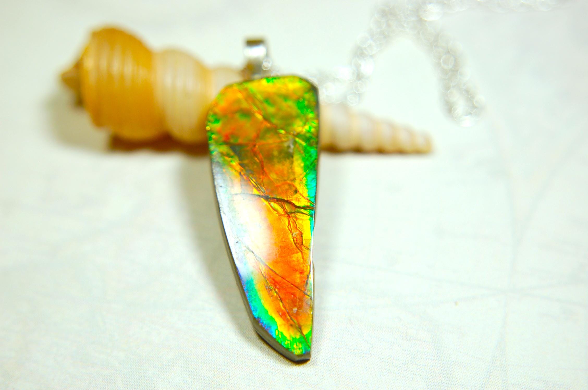 Ammolite necklace pendant.Natural rainbow cabochon of many bright colors.Strong color shifter.Video shows color best.030116