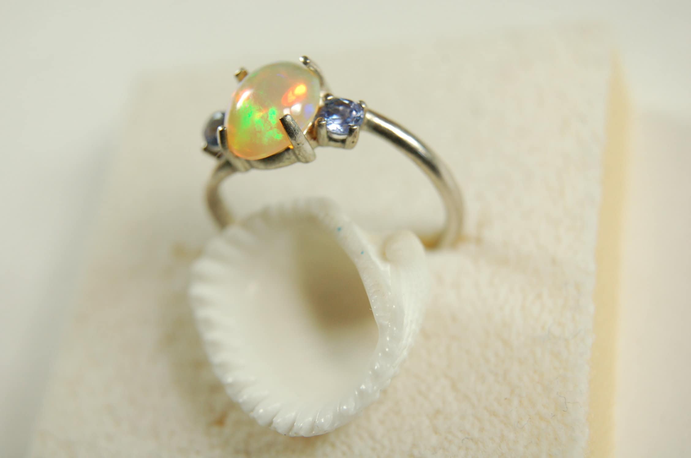 Opal ring.Solid African opal set in sterling silver with London Blue Topaz accent stones.Very feminine in size 6.