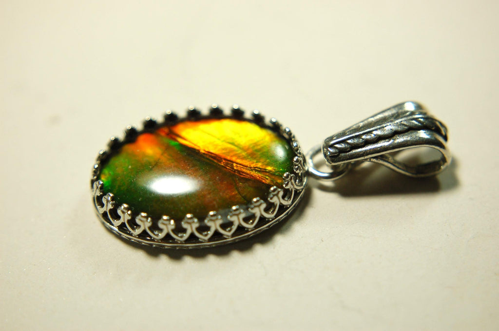 Ammolite Pendant Necklace.Resembles a fiery coal.Strong color shifter.Duty free under CUSMA rules.022115