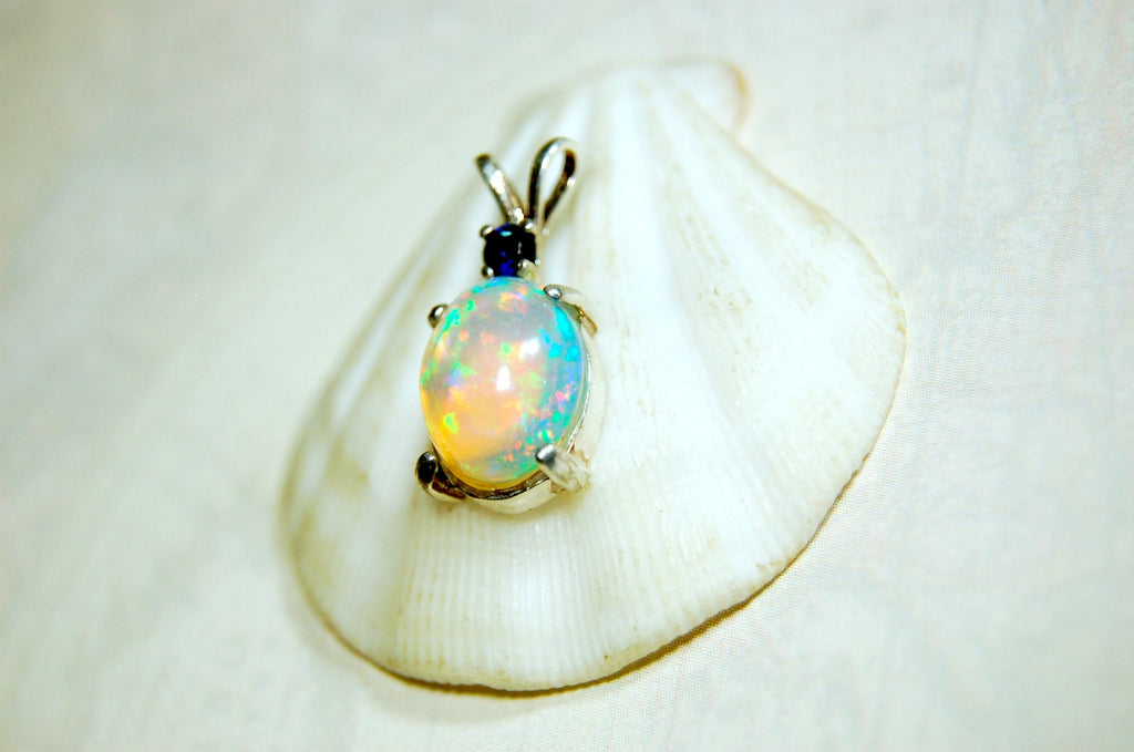 Natural opal pendant with blue sapphire.Good quality with many colors.The perfect gift.Must see video for true colors.042114