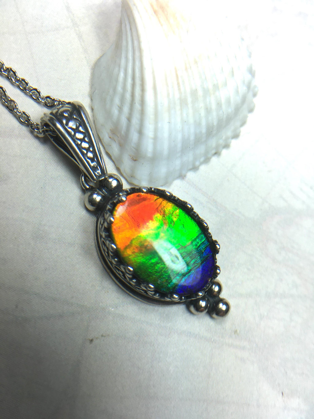 Genuine Ammolite Jewelry Pendant.Rainbow gem.Sterling Silver setting.No import taxes under CUSMA rules.062815