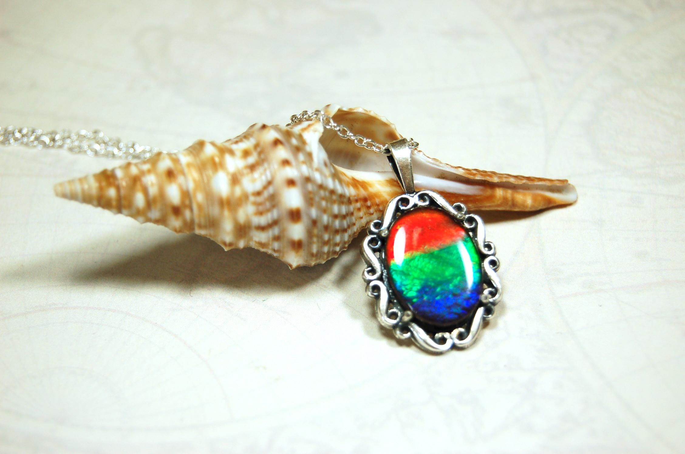 Genuine Ammolite Jewelry pendant with strong rainbow colors set in solid sterling silver.High Quality fashion accessory.