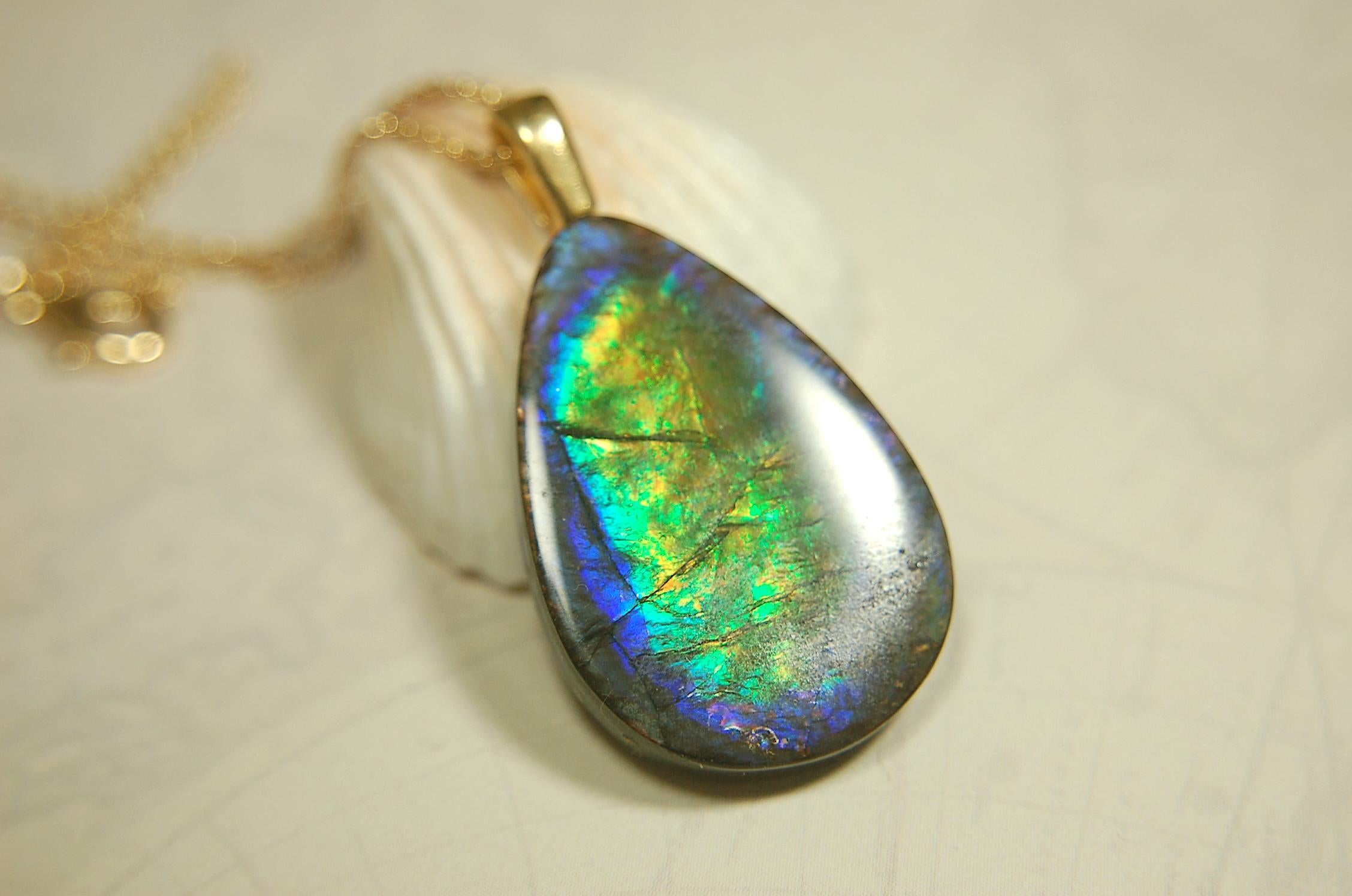 Ammolite Pendant with peacock colors.Natural cabochon gemstone mined and shipped from Canada.Gift of unique jewelry..020926