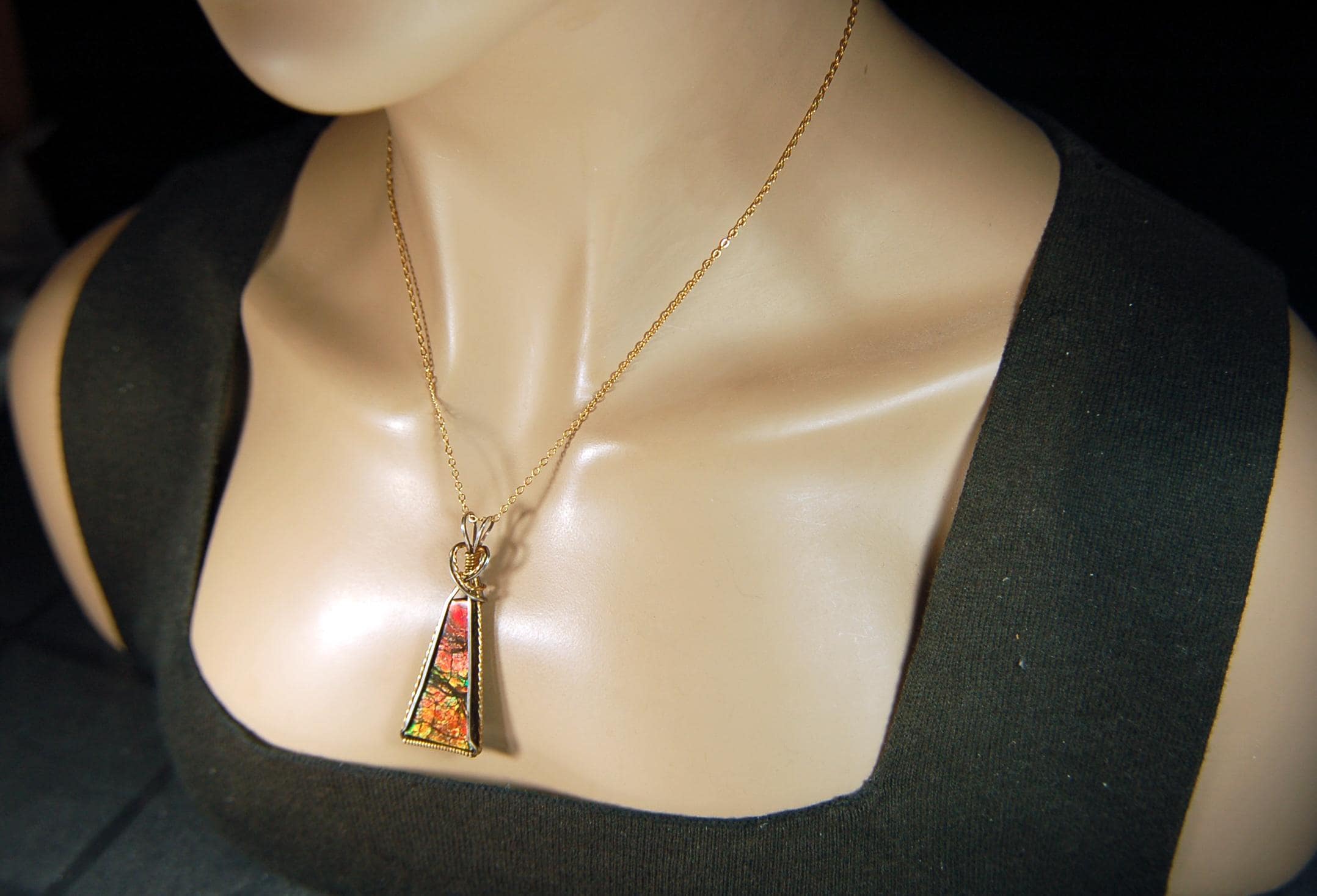 Unique Ammolite pendant set in Gold and sterling silver wire wrap.Natural cabochon in Canadian Maple fall colors.Must see video.082814