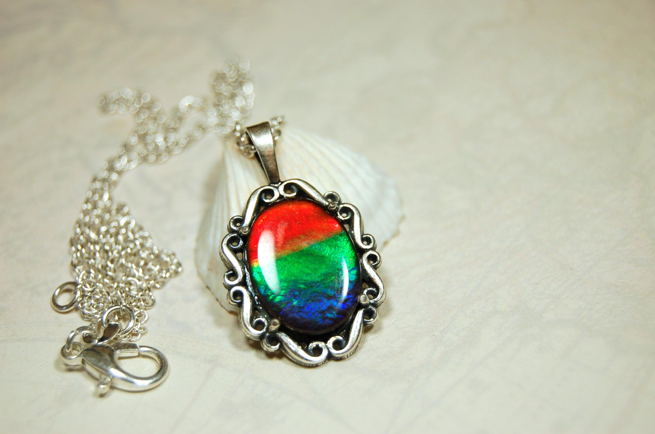 Genuine Ammolite Jewelry pendant with strong rainbow colors set in solid sterling silver.High Quality fashion accessory.