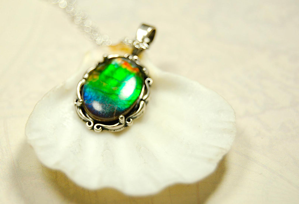Ammolite Pendant elegantly set in sterling silver.Lovely greens and blues and flash of red.Fine anniversary gift idea for  wife.041916