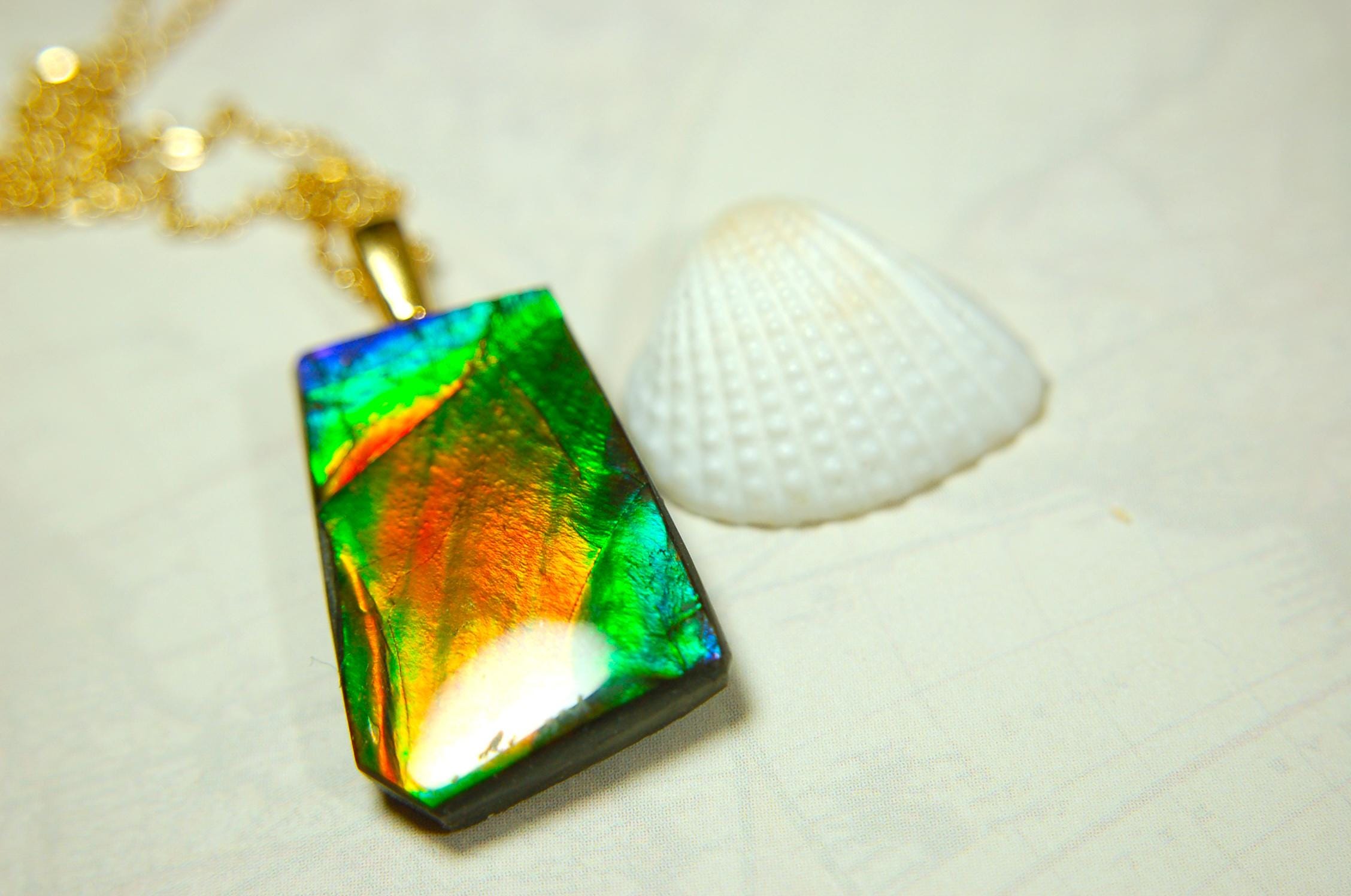 Ammolite pendant.Vivid colors in a high quality all natural cabochon with 14k gold filled bail.Fine fashion jewelry accessory 022516