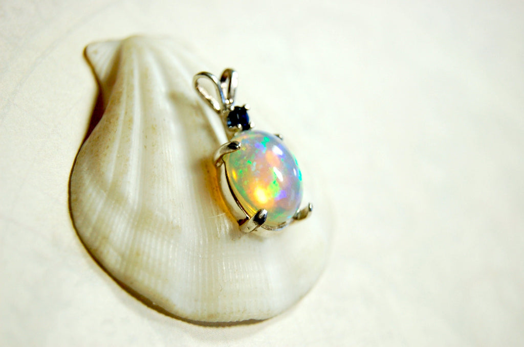 Natural opal pendant with blue sapphire.Good quality with many colors.The perfect gift.Must see video for true colors.042114