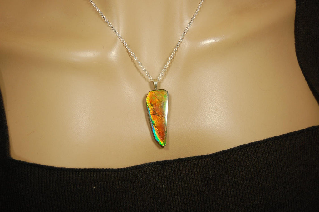 Ammolite necklace pendant.Natural rainbow cabochon of many bright colors.Strong color shifter.Video shows color best.030116