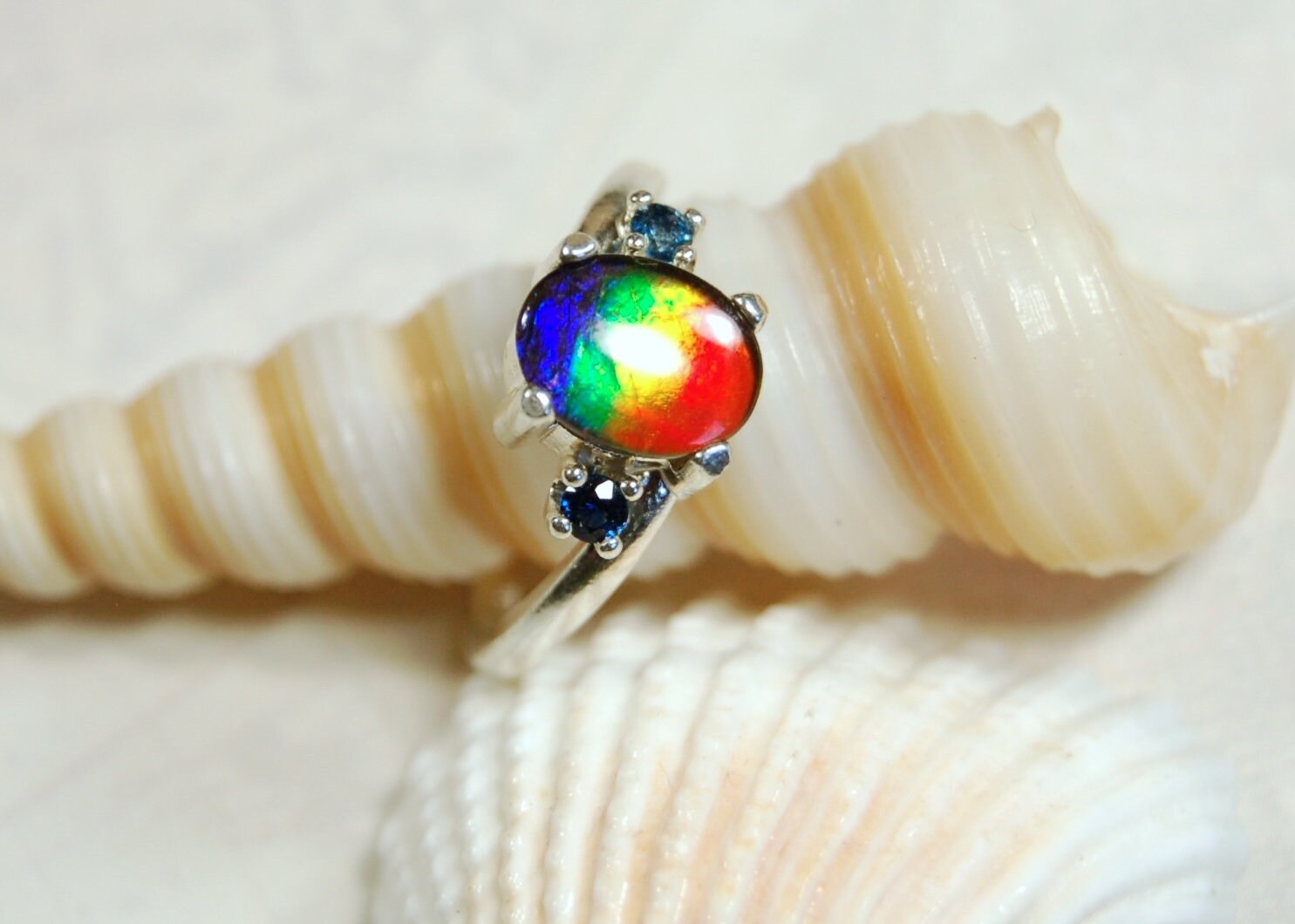 Ammolite Ring with Sapphire side stones.Lovely four color gem.Size 7.-#040314