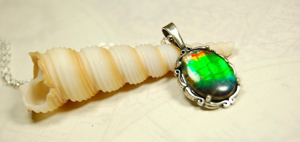Ammolite Pendant elegantly set in sterling silver.Lovely greens and blues and flash of red.Fine anniversary gift idea for  wife.041916