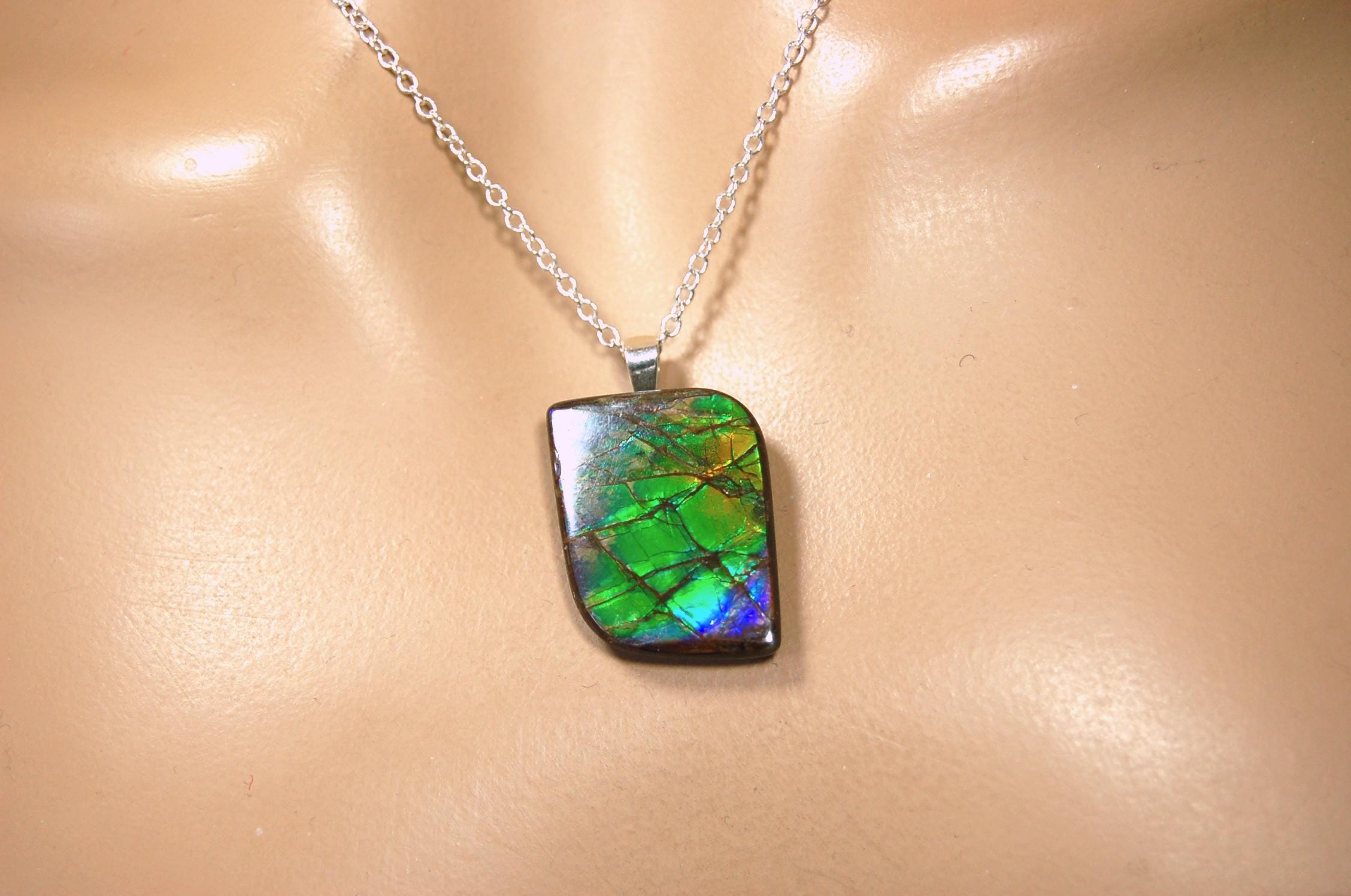 Ammolite Jewelry Pendant.Very high quality colors best seen in video.All natural cabochon gemstone from Alberta,Canada.031916