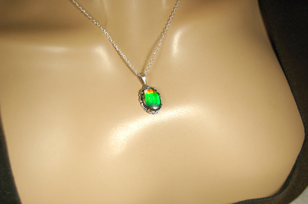 Ammolite Pendant elegantly set in sterling silver.Lovely greens and blues and flash of red.Fine anniversary gift idea for  wife.041916