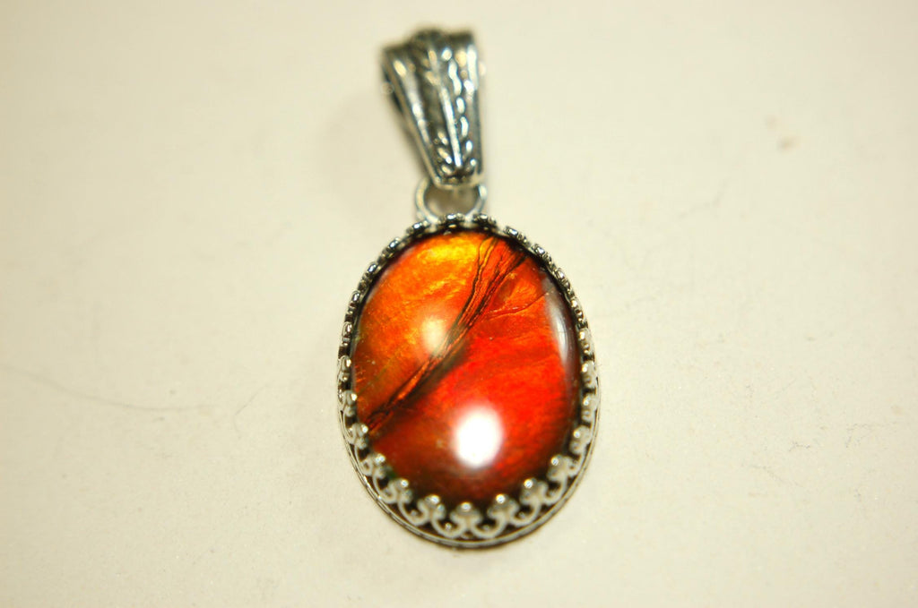 Ammolite Pendant Necklace.Resembles a fiery coal.Strong color shifter.Duty free under CUSMA rules.022115