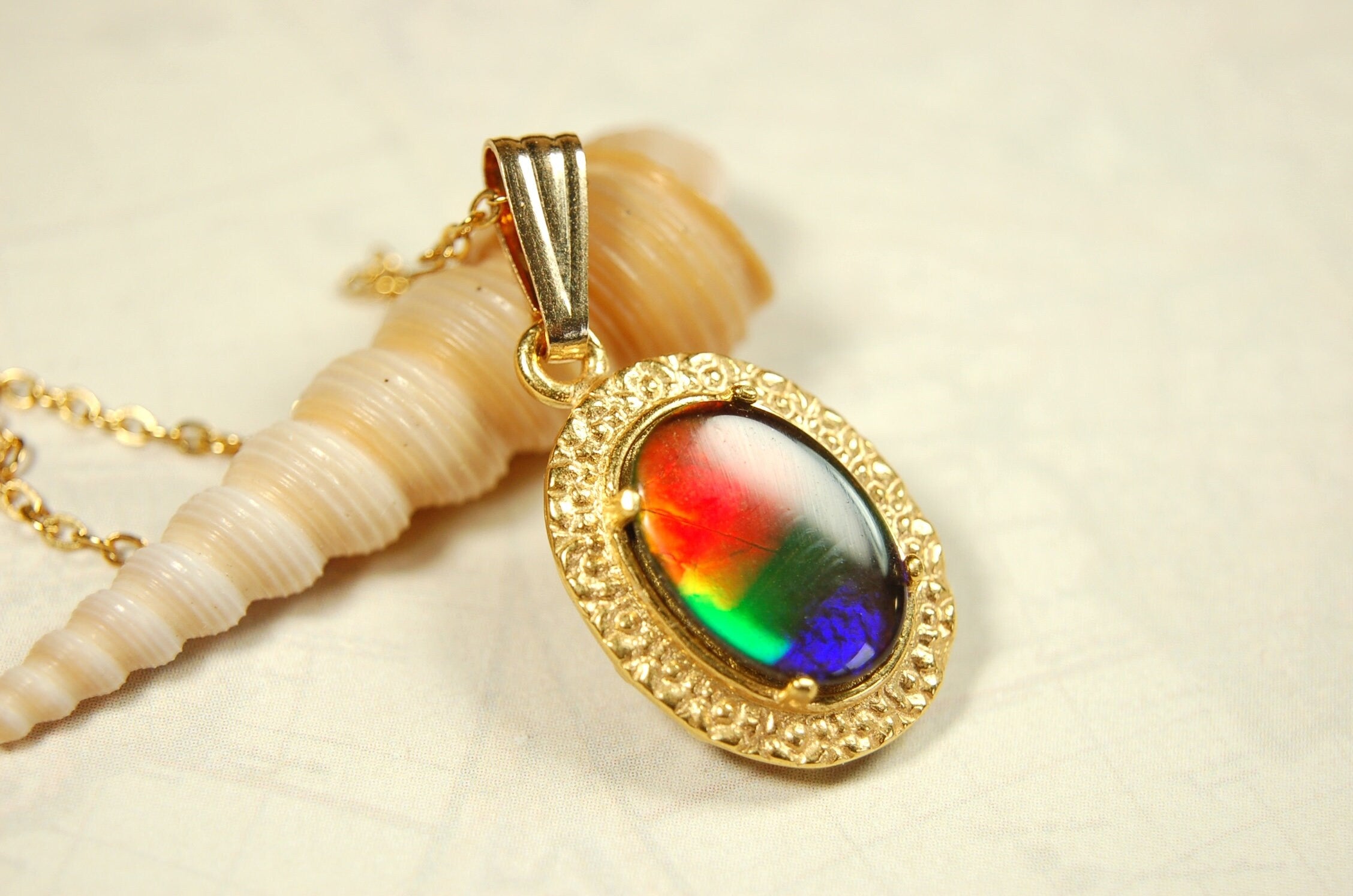 Genuine rainbow Ammolite pendant in 14k gold fill setting.#070414