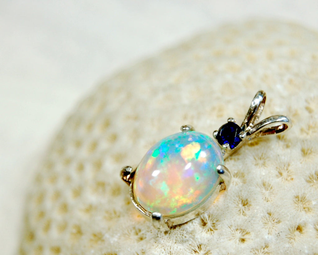 Natural opal pendant with blue sapphire.Good quality with many colors.The perfect gift.Must see video for true colors.042114