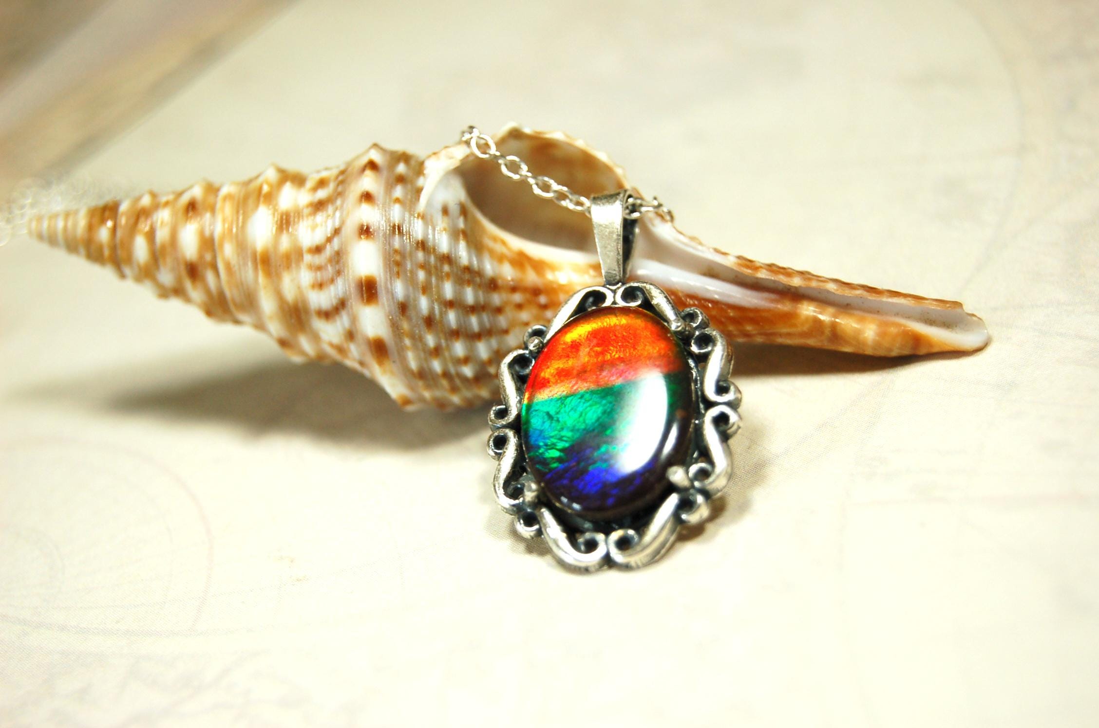 Genuine Ammolite Jewelry pendant with strong rainbow colors set in solid sterling silver.High Quality fashion accessory.