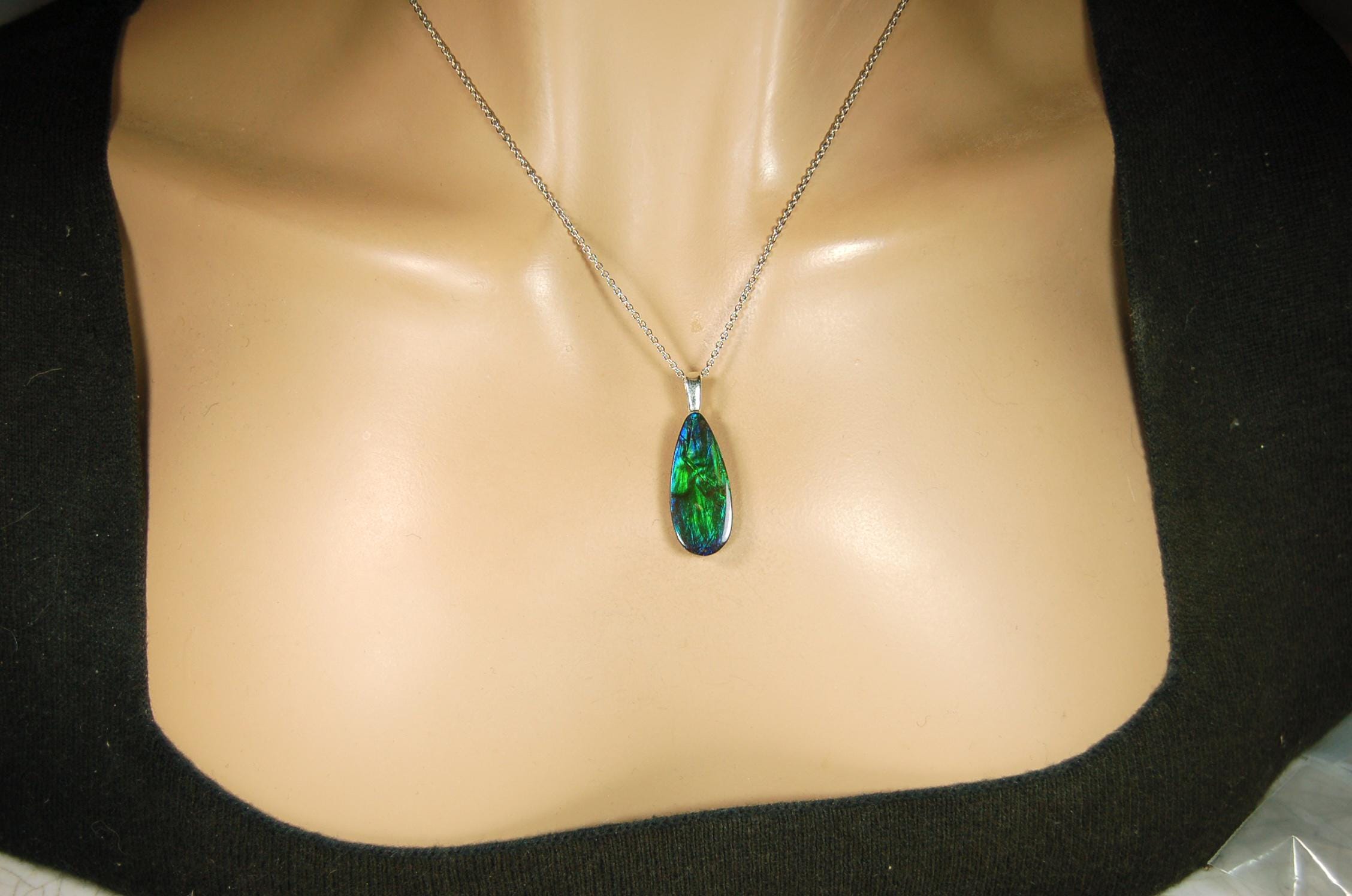 Ammolite Jewelry Pendant.All natural high quality cabochon from Alberta Canada.070715