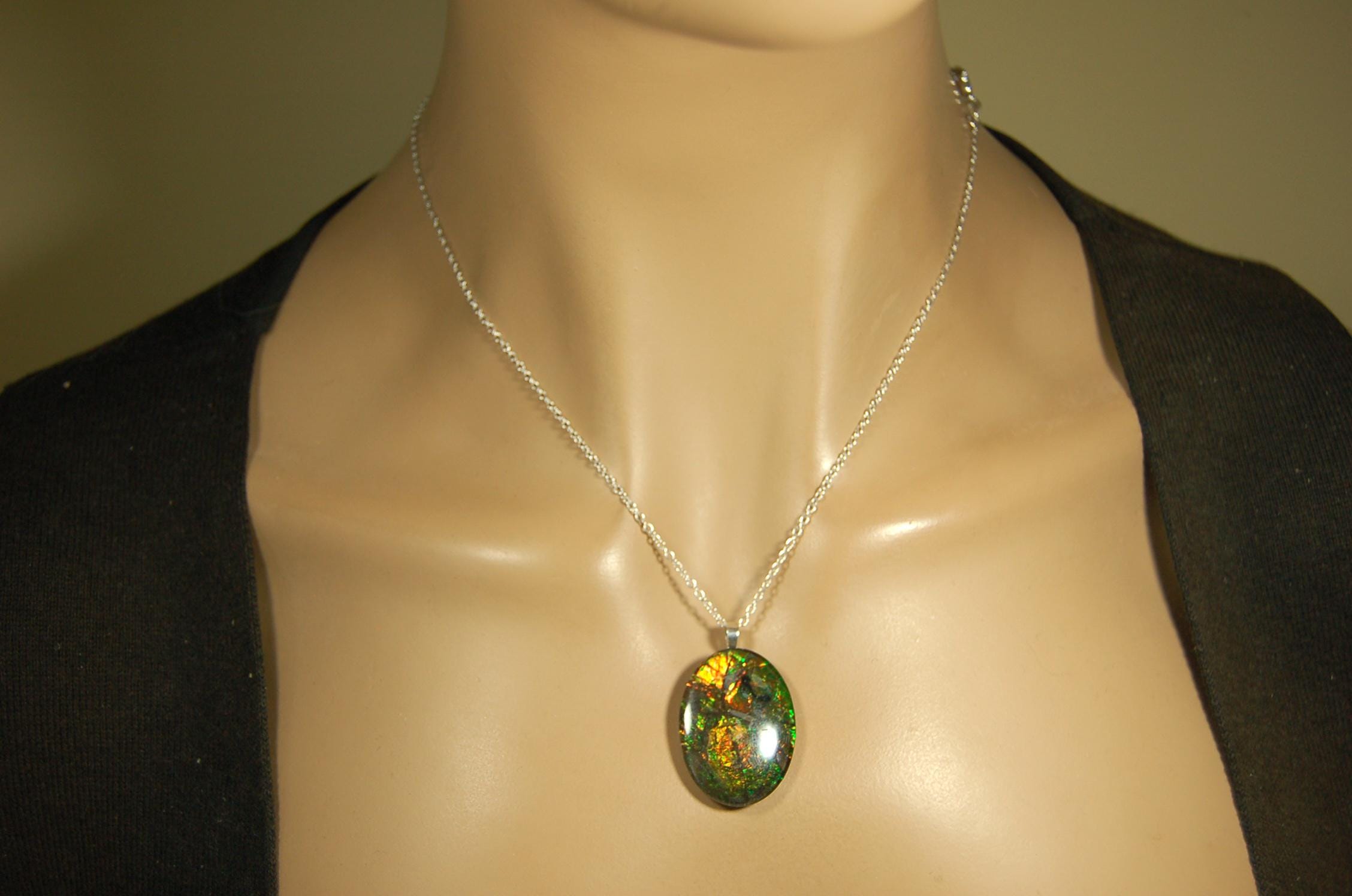 Ammolite cabochon pendant to upgrade your fashion accessory collection.Green and Copper colors.Sterling silver bail.Birthday gift? 032716