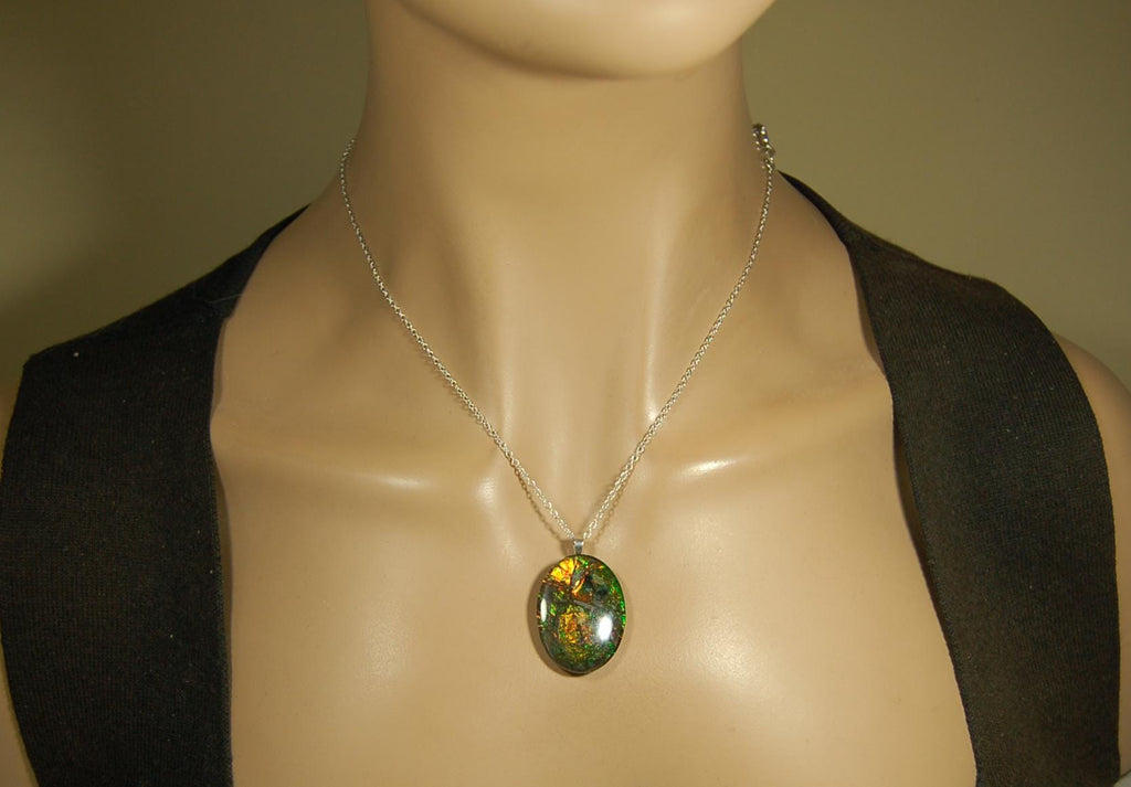 Ammolite cabochon pendant to upgrade your fashion accessory collection.Green and Copper colors.Sterling silver bail.Birthday gift? 032716